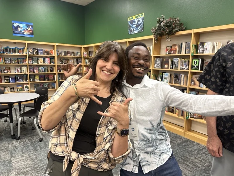 Marie Feutrier laughing with a fellow Gilbert Toastmasters member after the Tall Tale contest