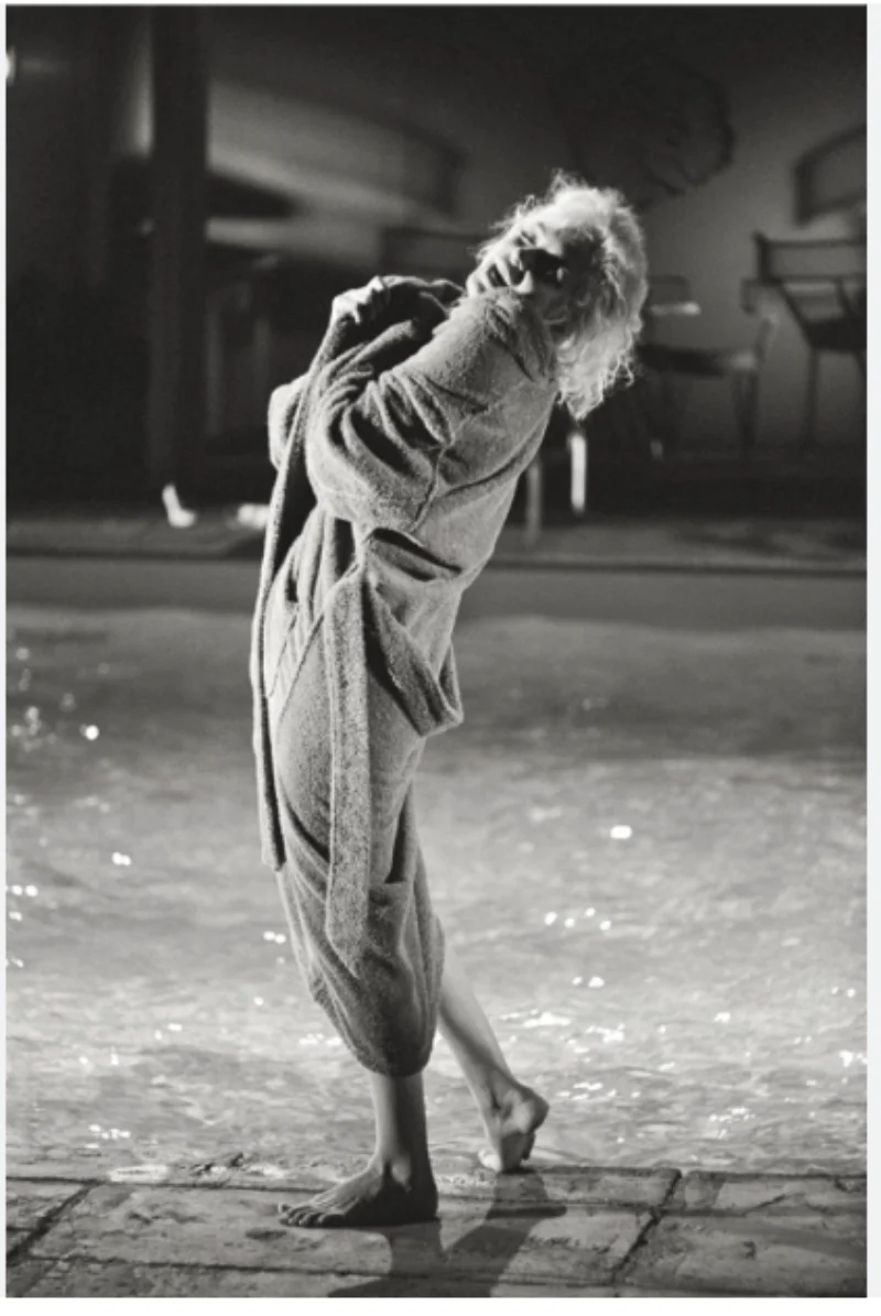 Marilyn Monroe dancing barefoot in a robe, black and white photograph by Lawrence Schiller