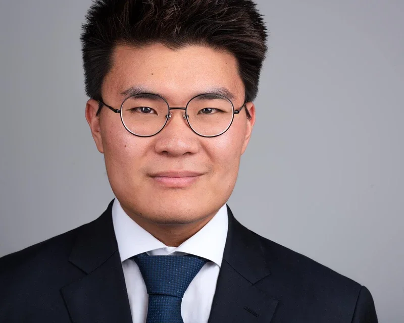 Finance professional in a navy suit and navy tie for a classic Phoenix executive headshot photographed in Gilbert Arizona