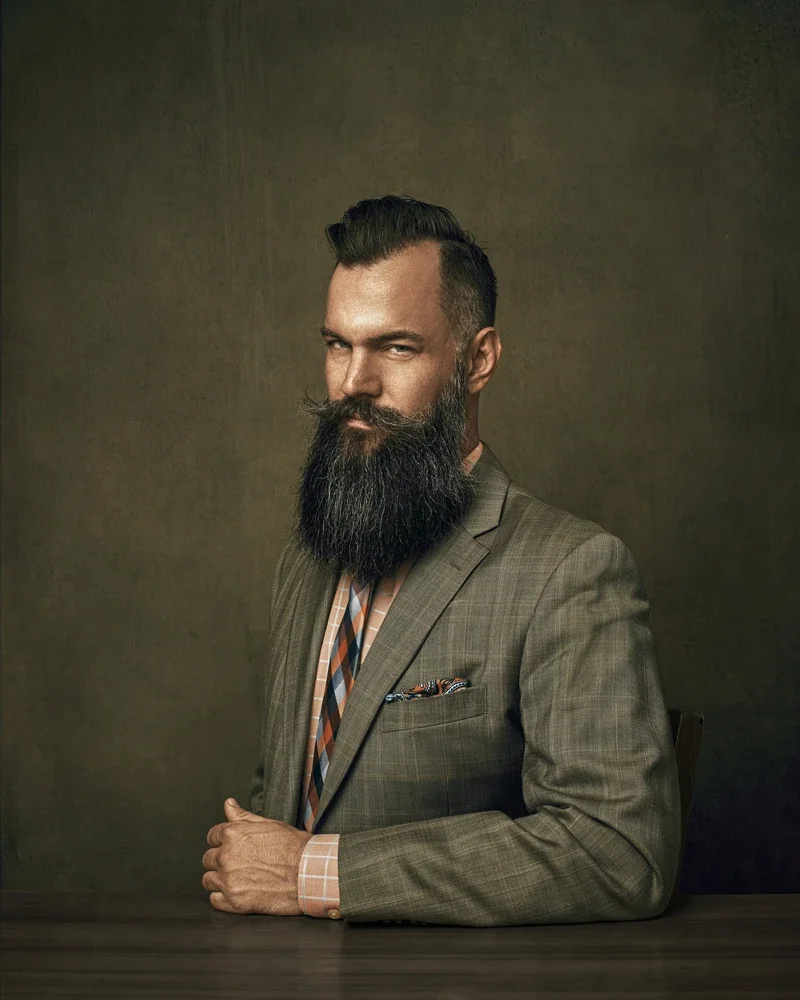 Phoenix client in a gray plaid blazer with a patterned tie and coordinated pocket square, photographed at Marie's Gilbert Arizona headshot studio