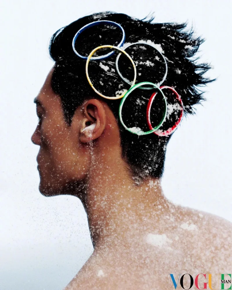 Profile portrait of a man with Olympic rings woven into his snow-dusted hair, photographed by Win Tam for Vogue China's Team China 2026 Winter Olympics editorial