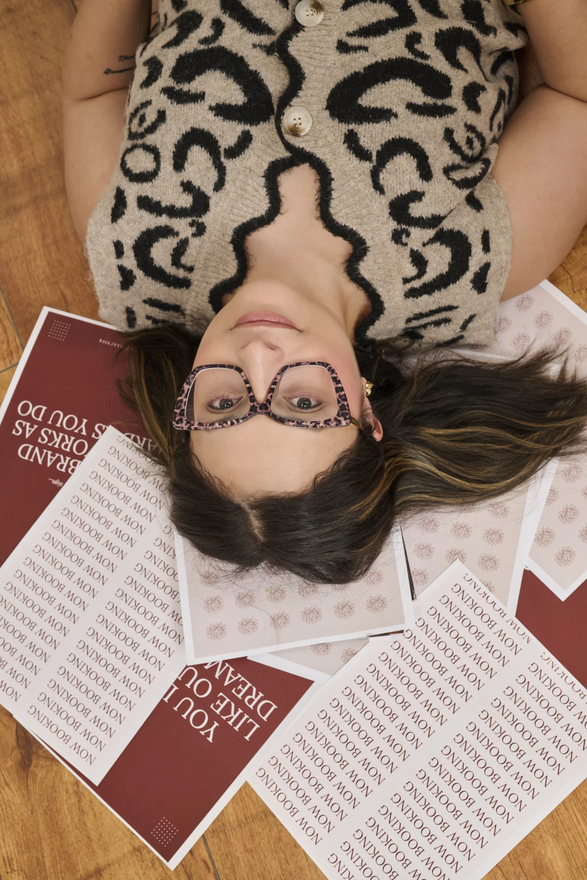Overhead personal branding photo of Caulene Flores lying among her printed brand cards, Phoenix Arizona