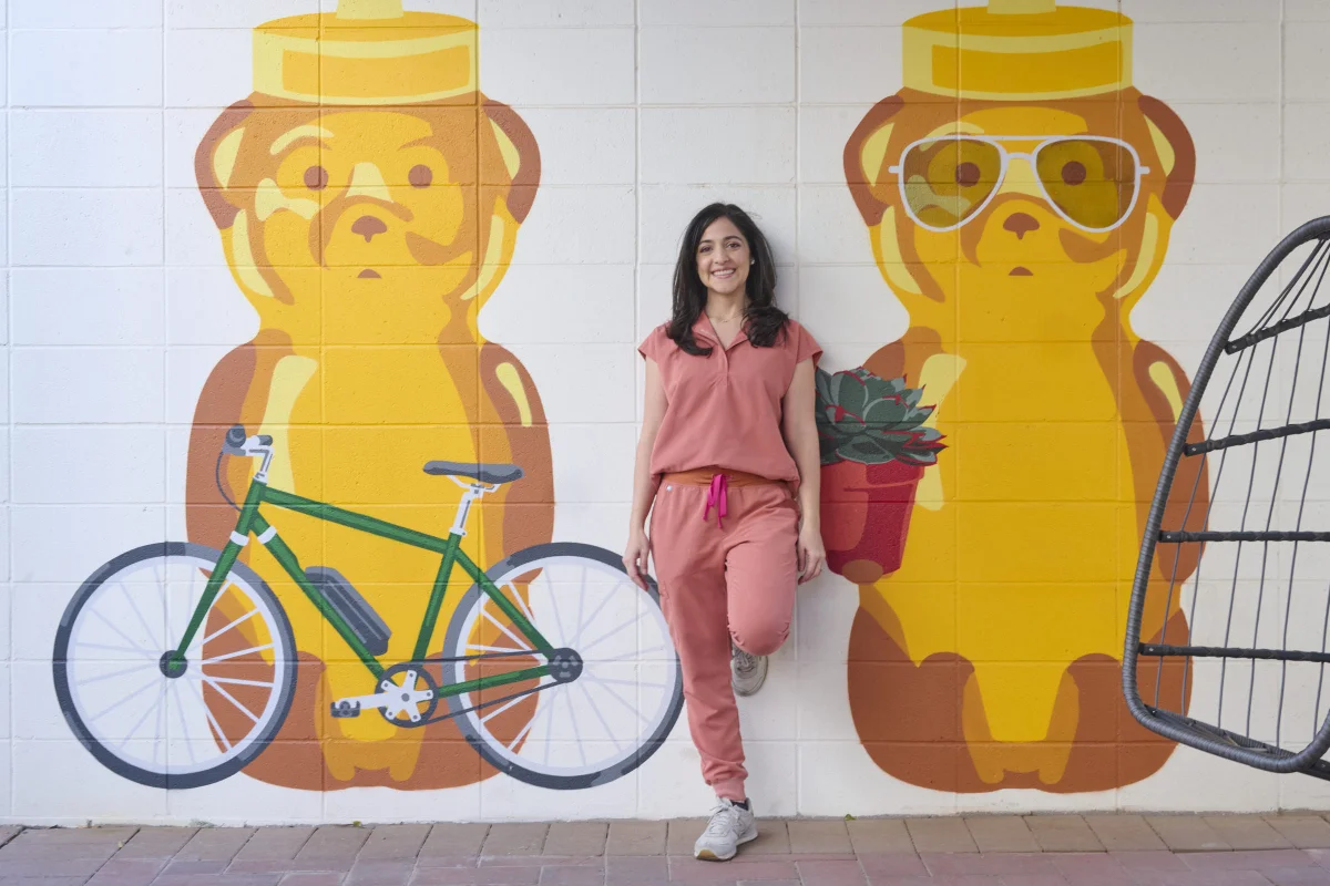 Personal branding photography session with Sarah in front of a colorful honey bear mural in Phoenix Arizona