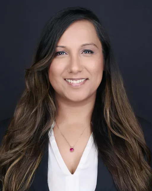 Pooja executive headshot in dark blazer warm professional portrait Phoenix Arizona