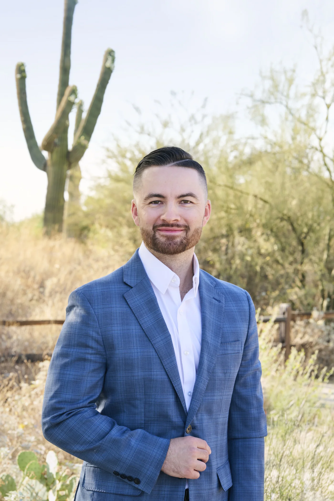 Professional headshot photographer in Phoenix Arizona desert with saguaro cactus