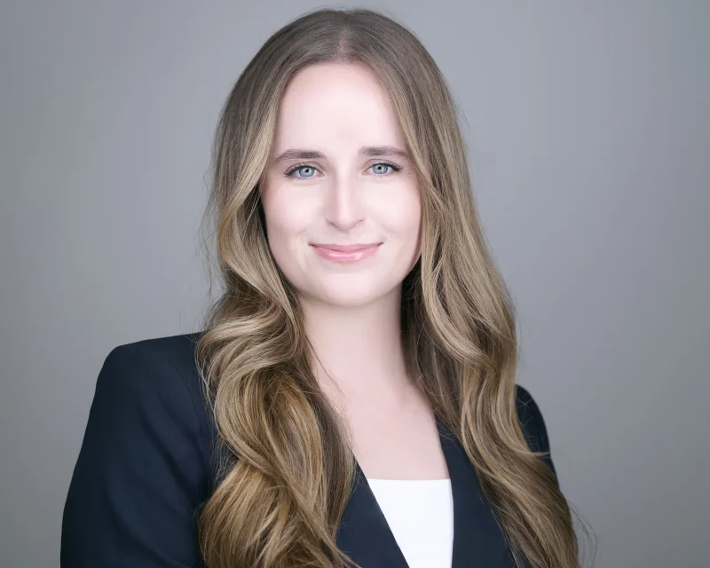 Professional woman in polished outfit ready for corporate team headshot session